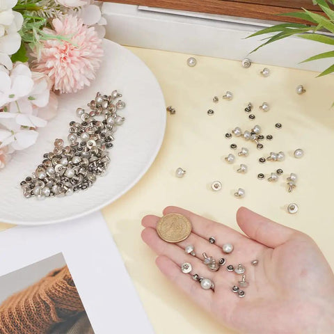 Hella Sturdy 100 Piece Brass Dome Studs Kit Featuring Easy Install Nailhead Screw Back Design For Heavy Duty Leather Repair Belts Motorcycle Boots Denim Jackets And Custom Garment Craft That Looks Totally Fresh, showcasing brass and silver dome studs in hand and plate.