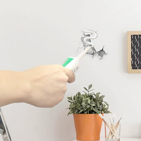 Close-up of All Purpose Wall Putty Repair Kit With Nozzle For Drywall Spackle Paste being applied to a wall hole next to a potted plant.