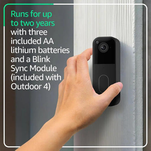 Hella Durable Wireless Security Camera Bundle With Video Doorbell Offering Two Year Battery Life For Zero Stress Setup And Badass Night Vision Coverage. A hand mounting the video doorbell on a textured wall.