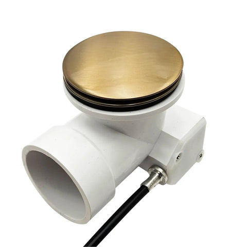 Top Shelf 35 Inch Cable Driven Bath Drain Trim Kit With Rotary Overflow Cover And Smooth Pop Up Stopper Featuring Schedule 40 PVC Construction And Slick Champagne Bronze Finish - Close-up view of brass stopper and PVC connector.