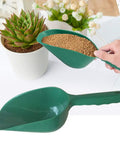 Person using All-Purpose Plastic Garden Soil Scoop Shovel to fill pot, lightweight durable PP tool for easy planting and potting.