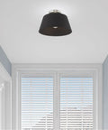 One Light Brushed Nickel Ceiling Mount Fixture With Black Accents in hallway, showcasing sleek modern design and easy installation.