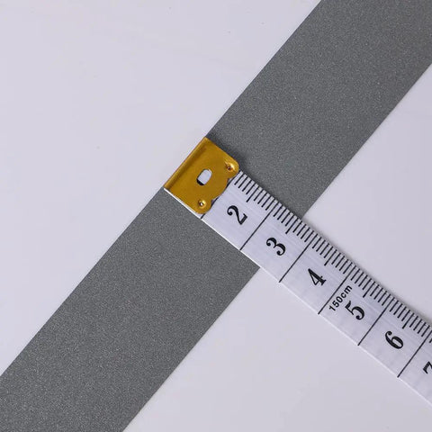 High Visibility Silver Reflective Sew On Fabric Tape Strips For Clothing Edging, 1 Inch By 20 Yards next to measuring tape