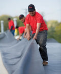 Heavy Duty 45 Mil Epdm Roofing Membrane 10 Feet By 200 Feet Roll For Flat Roofs And Low Slopes utilized by workers on a roof.