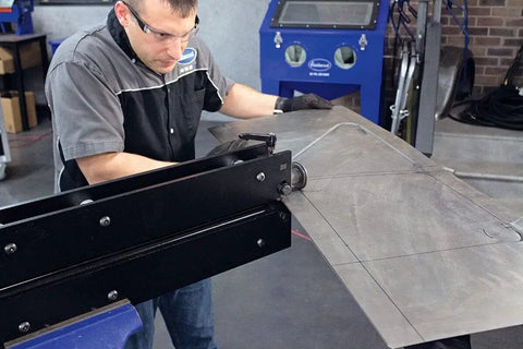 Technician using Elite Bead Roller With 27 Inch Throat Capacity for Floor Pans Firewalls trunk floors and inner fenders in metal shop