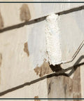 Wall section with High Build Peel Bonding Primer For Durable Seal applied, showing primer coverage over cracks and stains.