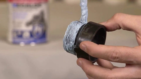 Applying Megaloc Multi-Purpose Thread Sealant For Pipes And Fittings, Blue Liquid Paste, 16 Oz Can on a plastic pipe thread