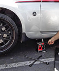 3 Ton Bottle Jack And Jack Stands In One Car Lift For SUVs And Trucks Heavy Duty Unijack under a parked car with safety bar engaged