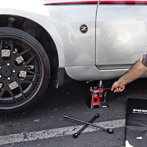 3 Ton Bottle Jack And Jack Stands In One Car Lift For SUVs And Trucks Heavy Duty Unijack under a parked car with safety bar engaged