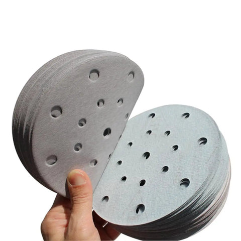 Get Ready To Rock Your Woodwork With A Pack Of 100 Versatile 6 Inch Sanding Discs, showing stacked pads with 17 holes.