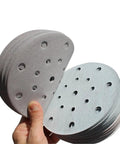 Pack of 100 Premium Aluminum Oxide Sanding Discs For Orbital Sanders featuring 400 Grit Anti-Clog Design shown from above, ready for use.
