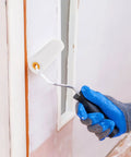 Hand using a mini foam paint roller on a wall with gloves applying glossy paint with 10 Pack High Density Foam Paint Roller Covers Mini Wall Paint Rollers Quick And Dirty Setup Knockout Coverage For Water Based And Oil Based Paints Gloss Stains Real Smooth Finish Home Workshop Needs.