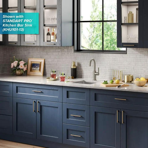 Oletto Single Handle Kitchen Bar Faucet in Spot Free Stainless Steel, installed in modern kitchen setting with blue cabinets.