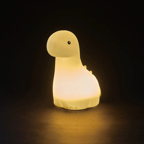 Multicolor LED Silicone Night Light Brontosaurus Tap Light For Kids Nursery Decor Rechargeable Color Changing Soft BPA Free Body Cozy Sleep Glow Bedtime Routine glowing warm light in dark setting.