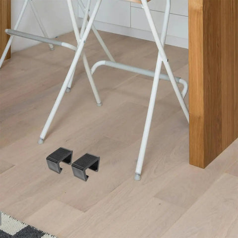 4 Pack Black Plastic Outdoor Furniture Clips for Sofas and Beds with firm grip on wooden floor by white metal chair legs