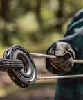 Close-up of a Soft Shackle For Off Road Recovery 30,800 Lbs Breaking Strength in use with a synthetic rope and hands in gloves.