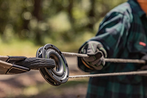 Close-up of a Soft Shackle For Off Road Recovery 30,800 Lbs Breaking Strength in use with a synthetic rope and hands in gloves.