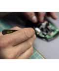 Close-up of hand using 65 Piece System 4 ESD Safe Master Technician Ratchet And MicroBits Set on electronic circuit board.