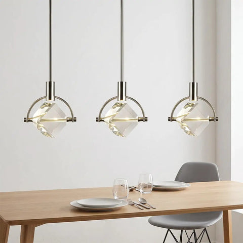 Lamparko Small Pendant Light Fixture with Crystal Cube, Brushed Nickel, three hanging lights over a dining table.