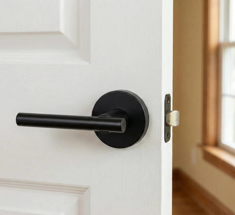 Black Passage Door Lever Set installed on white door, visible lever and strike plate, adjustable backset, modern home upgrade.