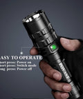 Hand holding Zoomable Green Light 1200 Lumen Rechargeable LED Flashlight for Outdoors and Hunting, USB charging, five modes.