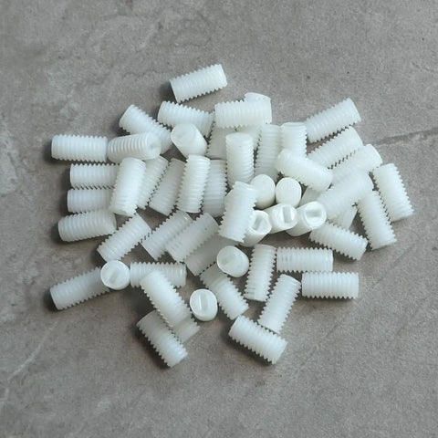 Heavy Duty M6 X 12mm White Nylon Set Screws Insulated Non Conductive Plastic Grub Bolts With Crisp Slotted Heads in a pile.