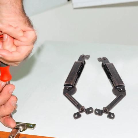 Heavy Duty Spring Lid Stay Hinges With Sweet Antique Red Iron Finish Tough As Nails Cabinet Hardware being installed on wood.