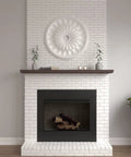 Ceiling Medallion With Thirty One And Five Eighths Inch Outside Diameter And Three And Five Eighths Inch Inner Diameter Fits Canopies Up To Three And Five Eighths Inches Lightweight Easy Install With Common Tools Exquisite Detailing Factory Primed shown on a white brick wall above a fireplace.