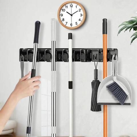 Heavy Duty Broom Holder Wall Mount Organizer 2 Pack With 5 Adjustable Slots And 6 Foldable Hooks in use holding cleaning tools