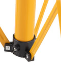 Detail of Adjustable Telescopic Metal Archery Target Stand in Bright Yellow for Backyard Practice, tripod base close-up.