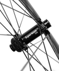 Close-up of hub on Carbon Disc Wheelset with Wave Rim 50CU 25 CC Thru Axle 12x100 for road and gravel bikes.