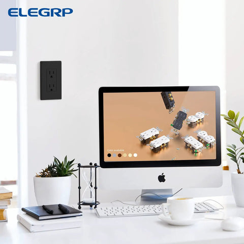 Matte Black Standard Decorator Electrical Wall Receptacle Outlet 15A 125V NEMA 5-15R in office setting with monitor