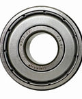 Close-up view of one 6201ZZ deep groove ball bearing with metal seals for high-speed rotation and axial loads, steel cage visible.