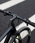 Premium Foam Lock On Bike Grips For Mountain Biking And More, Non Slip Ergonomic Handlebar Grips on black bike in urban setting