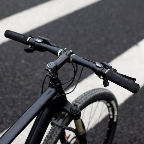 Premium Foam Lock On Bike Grips For Mountain Biking And More, Non Slip Ergonomic Handlebar Grips on black bike in urban setting