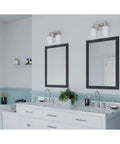 Alexa Collection 2 Light Bath Vanity Light With Dope Etched Linen Glass shown above dual mirrors in bathroom setting.