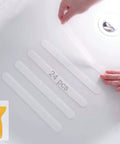 Applying Grippy Non Slip Bathtub And Shower Stickers Set 24 Pieces 8 By 0.8 Inch Anti Skid Treads Tape on a tub with a yellow scraper