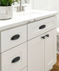 10 Pack Matte Black Cup Pulls Three And Three Quarters Inch Hole Center Zinc Alloy Cabinet Handles installed on white bathroom drawers