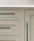 30 Pack 3 Inch Center To Center Solid Matte Black Cabinet Pulls on kitchen drawers and cabinets, showing slim square bar handles.