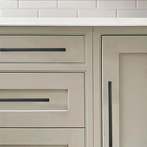 30 Pack 3 Inch Center To Center Solid Matte Black Cabinet Pulls on kitchen drawers and cabinets, showing slim square bar handles.
