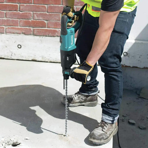Man using Beast Mode 8 Amp SDS Plus AVT Rotary Hammer With D Handle 1 Inch Chuck Two Point One Ft Lbs Impact Energy on concrete
