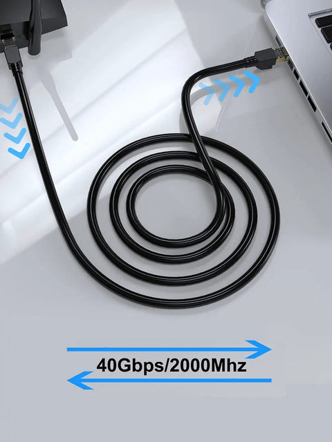 Coiled Beefy Cat8 Shielded Ethernet Cable 50 Ft Indoor Outdoor Direct Burial 26AWG SFTP Patch Cord connected to a laptop