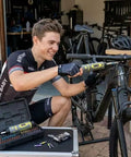Cyclist using Pro Grade Torque Wrench And Screwdriver Set With 40 S2 Bits for bike repairs in garage