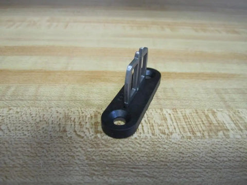 Az15 16 B1 Safety Interlock Switch with sliding door actuator on a wooden surface, stainless steel prongs visible
