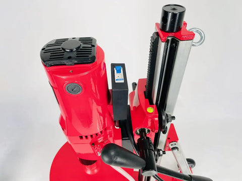 Straight Shooting Heavy Duty Workhorse Diamond Coring Drill With Tilting Rolling Base And Killer 12 Piece Wet Core Bit Set Pro Concrete Cutting Setup 110 Volt Dual Speed 2600 Watt Motor Crushes 12 Inch Cuts close-up of drill motor and tilt mechanism