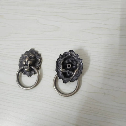 Front view of Antique Bronze Lion Head Ring Pull Cabinet Handles Set Of 4 With Screws, 2.6 Inches Long, on a light background.