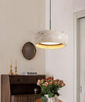 Modern Dome Yellow Travertine Pendant Light, Nordic Natural Stone Hanging Lamp over a wooden table with flowers.