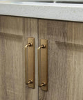 Two Pack 5 Inch Center To Center Antique Brass Cabinet Bar Pulls With Backplates installed on wooden cabinet doors