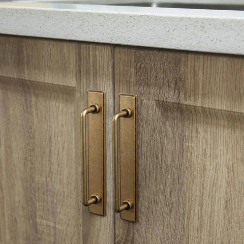 Two Pack 5 Inch Center To Center Antique Brass Cabinet Bar Pulls With Backplates installed on wooden cabinet doors