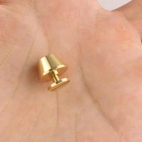 Top Shelf Solid Brass Screw Back Metal Studs With Knockout Gold Finish, 9mm stud in palm, ideal for leather craft and handbag hardware.